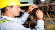 male electrician testing industrial machine